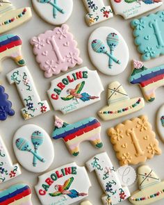 many decorated cookies are displayed on a table