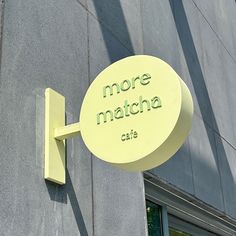 there is a sign that says more matcha cafe on the side of a building