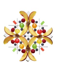 an arrangement of fruits arranged in the shape of a snowflake on a white background