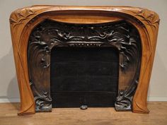 an ornate wooden fireplace surround with carved wood