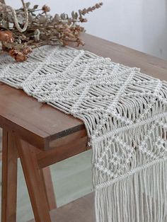 a white table runner on top of a wooden table