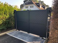 a large black gate in front of a house