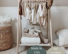 a baby crib with clothes hanging from it's rails and the words made in usa written below