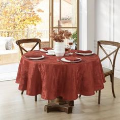 a dining room table set with place settings