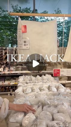 a woman is shopping for items in a store with the words ikea back on it