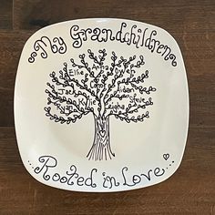 a white plate with a tree on it that says, my grandmother rooted in love