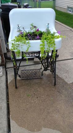 a white chair with some plants growing out of it