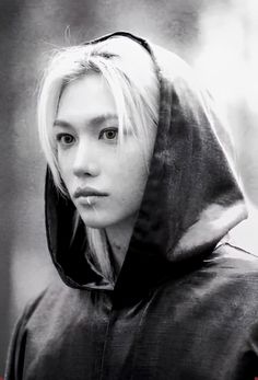 black and white photograph of a woman with blonde hair wearing a hoodie looking at the camera