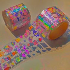 two rolls of colorful stickers sitting next to each other