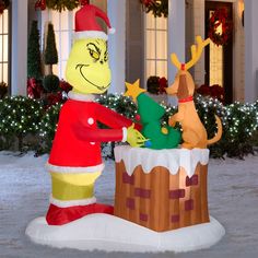 an inflatable christmas decoration with santa clause and reindeer