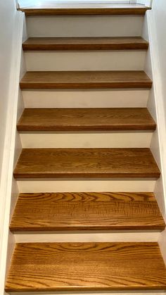 a set of wooden stairs leading up to a window