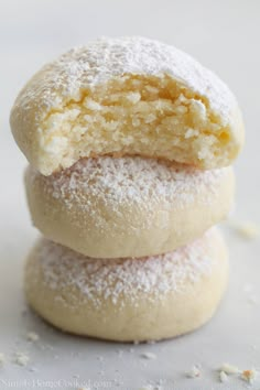 three powdered sugar cookies stacked on top of each other