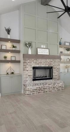 an empty living room with a fireplace and shelves