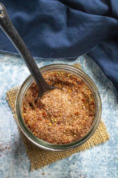 a spoon in a jar filled with spices