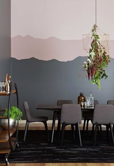 a dining room table with chairs and a potted plant on it's side