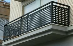 a black metal balcony railing on the side of a building