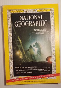 the front cover of national geographic magazine, with an image of two men working on