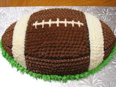 a cake shaped like a football on top of a table