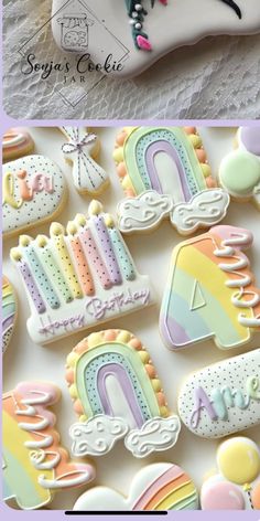 some cookies that are decorated with icing and rainbows on top of each other