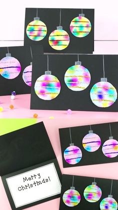 four christmas cards with ornaments hanging from them