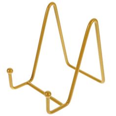 a gold plated metal object with two hooks on each side and one hook in the middle