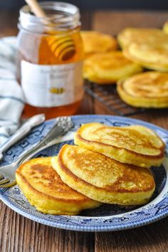 pancakes on a plate with honey in the background