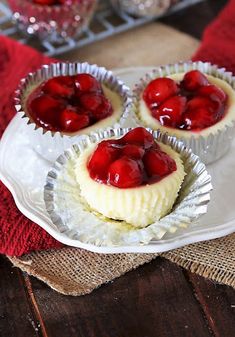 three small desserts on a plate with red cloth