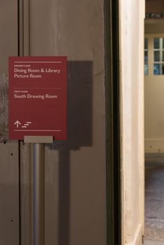 a red sign on the side of a door that says, disney room & library pictures room