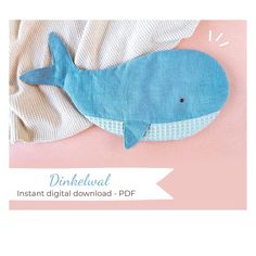 a blue whale stuffed animal laying on top of a pink background with the words dineeual instant digital download