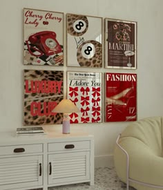 a living room with posters on the wall and a chair in front of a table