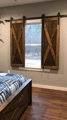 the bedroom has two sliding barn doors in it