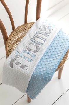 a blue and white towel sitting on top of a wooden chair