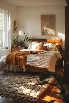 a bed sitting in a bedroom next to a window with plants on top of it