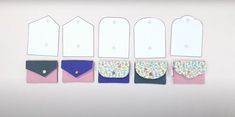 six envelopes are lined up in different colors and sizes, each with a flowered design