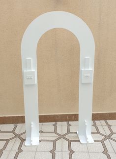 an arch with two white handles is on the floor