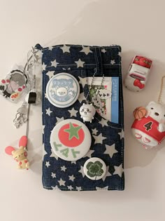 the contents of a purse are laid out on top of each other, including buttons and magnets