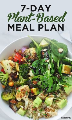 a white bowl filled with vegetables and rice on top of a table next to a fork