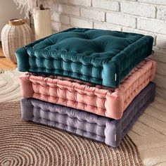 three different colored cushions stacked on top of each other