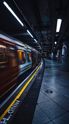 the train is moving fast through the subway station at night with motion blurs around it