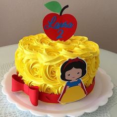 a birthday cake with yellow frosting and an apple on top