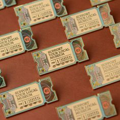 several tickets are sitting on a table with red paper and blue trimming around them