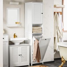 a bathroom with a sink, cabinet and bathtub