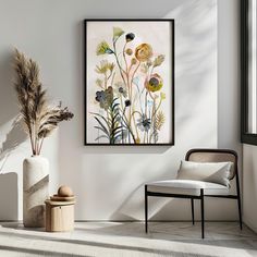 a white room with a chair, vase and painting on the wall next to it