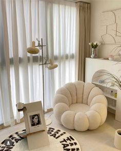 a living room filled with lots of furniture and decor on top of a white floor