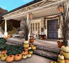 the front porch is decorated with pumpkins and gourds