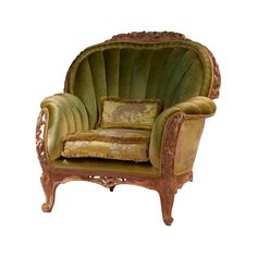 an ornate chair with green velvet upholstered cushions