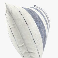 a blue and white striped pillow sitting on top of a table