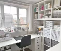 a white desk sitting under a window in a room