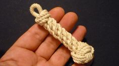 a hand holding a piece of rope in it's palm