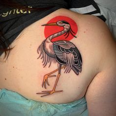 a woman with a bird tattoo on her back